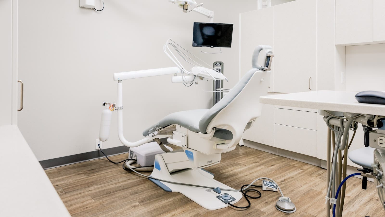 Modern dental operatory with a self-contained water bottle on the dental unit