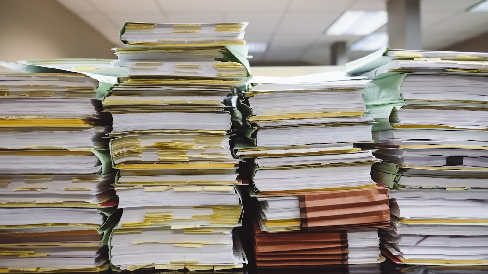 Stacks of tabbed patient files representing dental record retention in Ontario